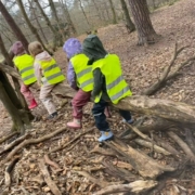 Kinder sitzen auf dickem Ast